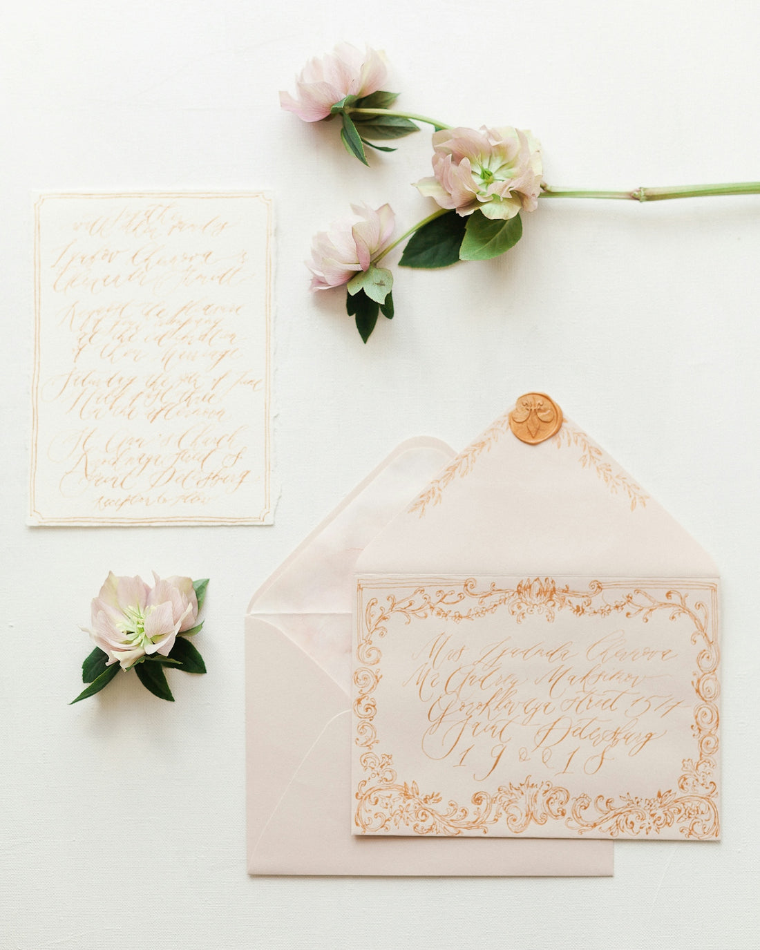 a wedding stationery with flowers and calligraphy